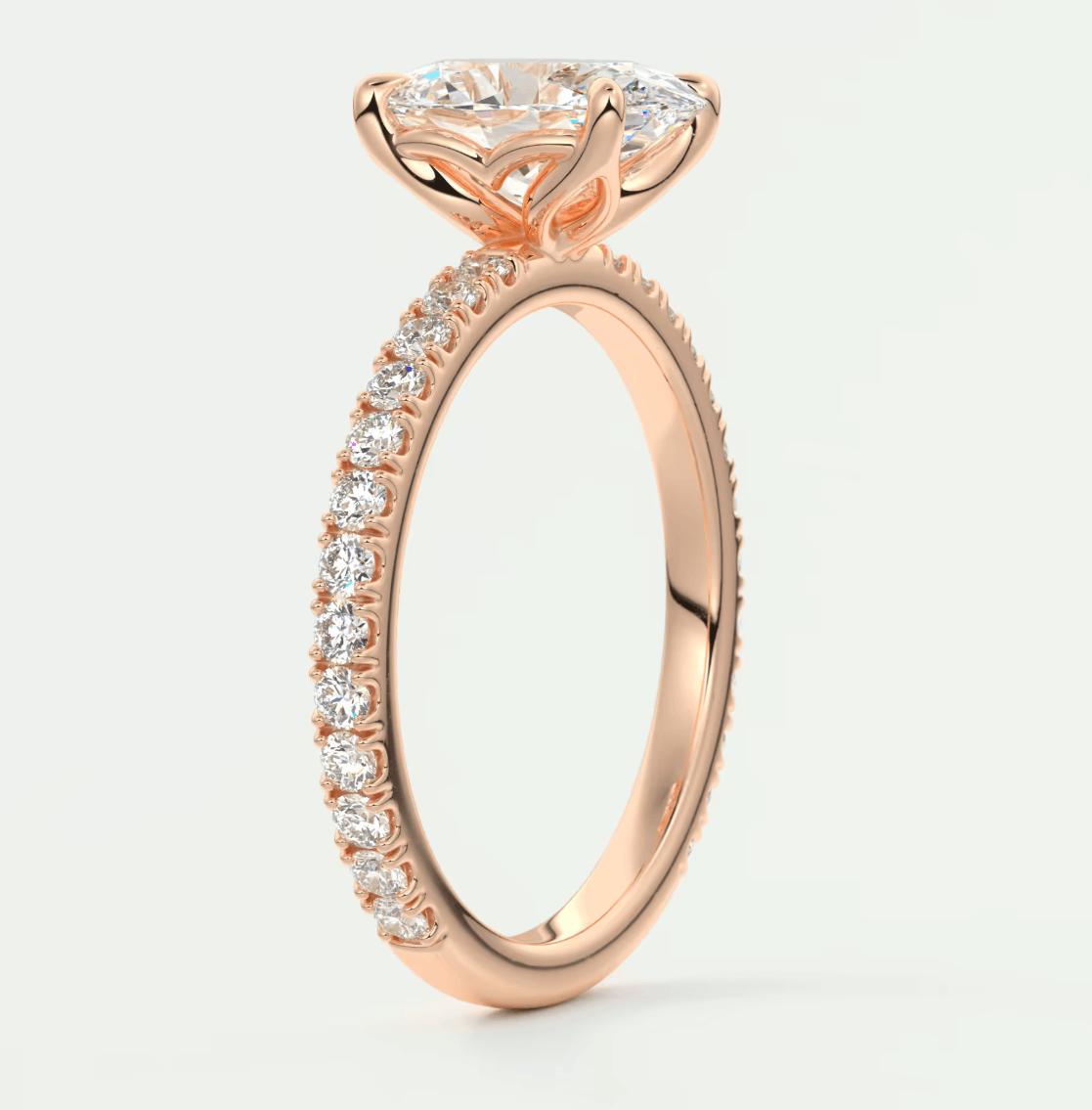 18-karat rose gold engagement ring with a princess-cut diamond and pavé side stones.