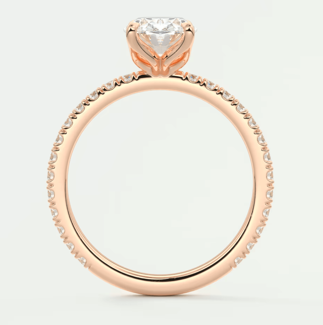 18-karat rose gold engagement ring with a heart-shaped diamond and small diamonds along the band.