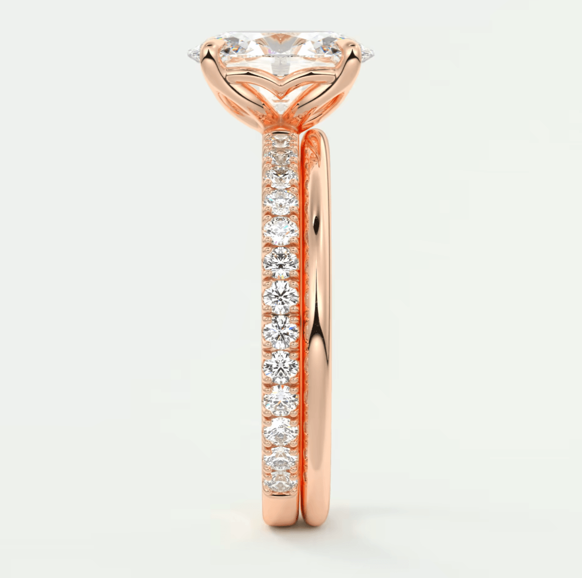 18-karat rose gold engagement ring with a central diamond and smaller diamonds along the band.