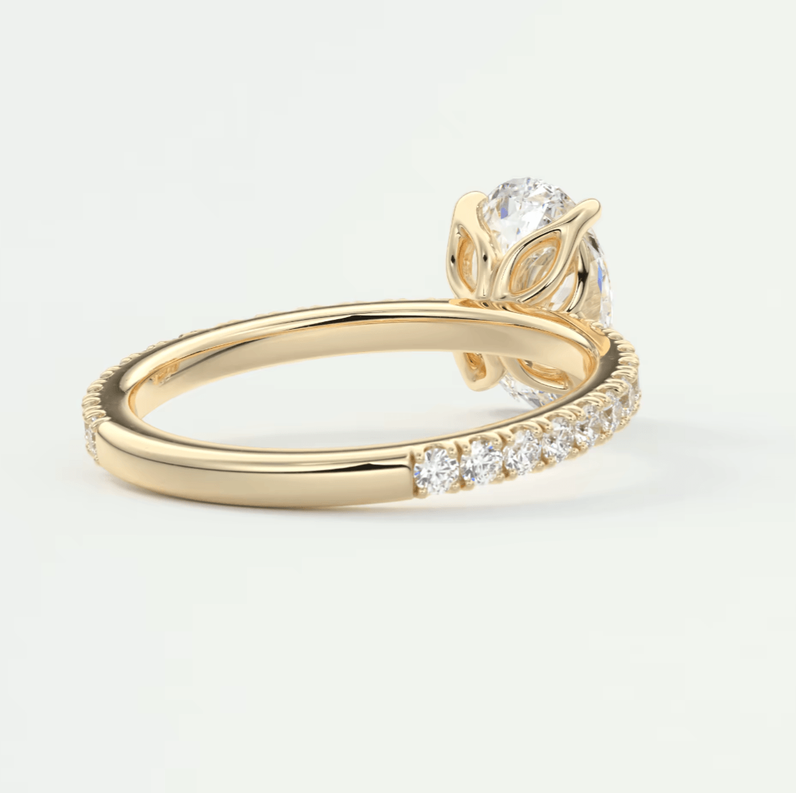 18k yellow gold engagement ring with a leaf and diamond halo design.