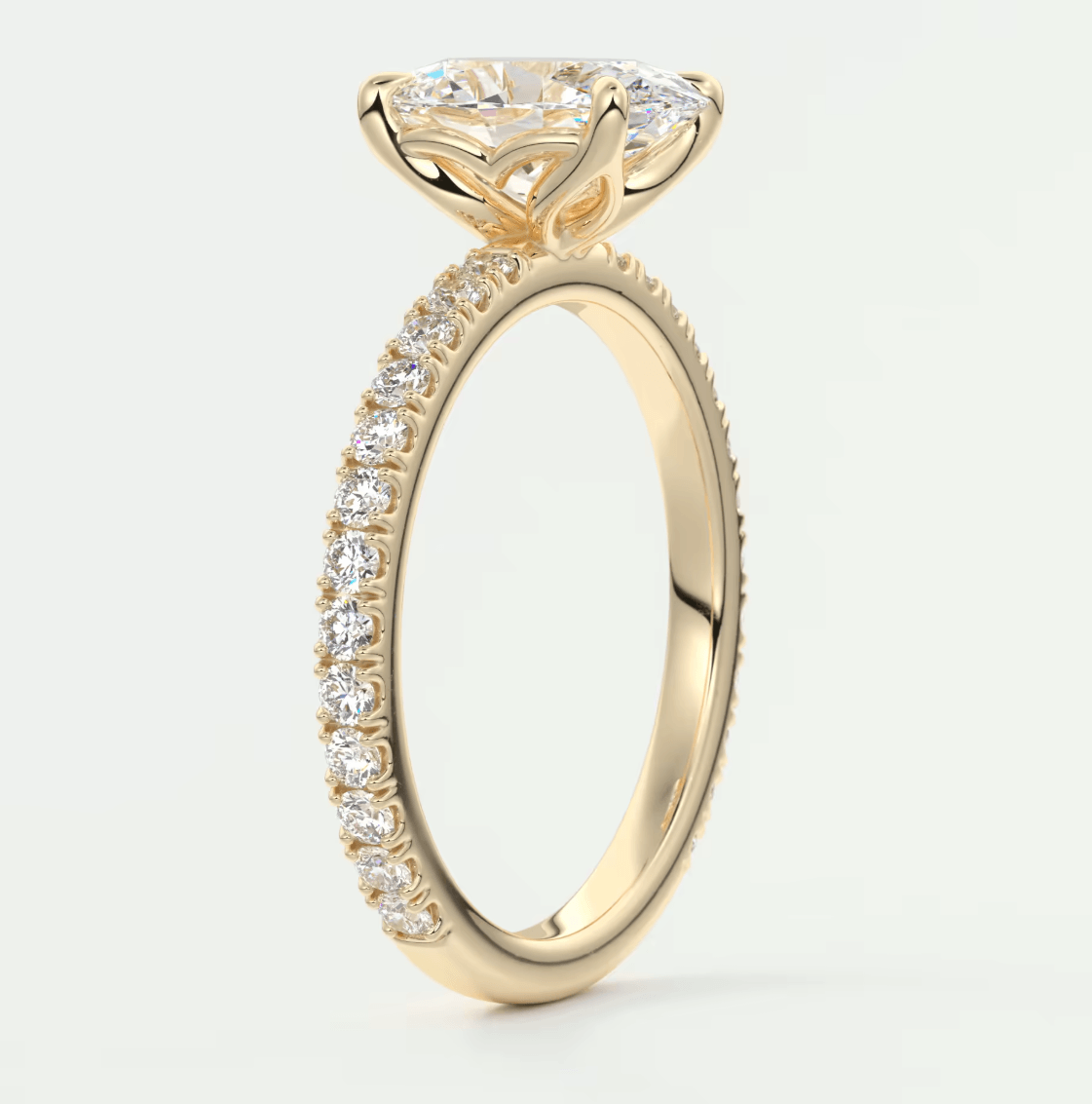 18k yellow gold engagement ring with a princess cut diamond and pavé set diamonds on the band.