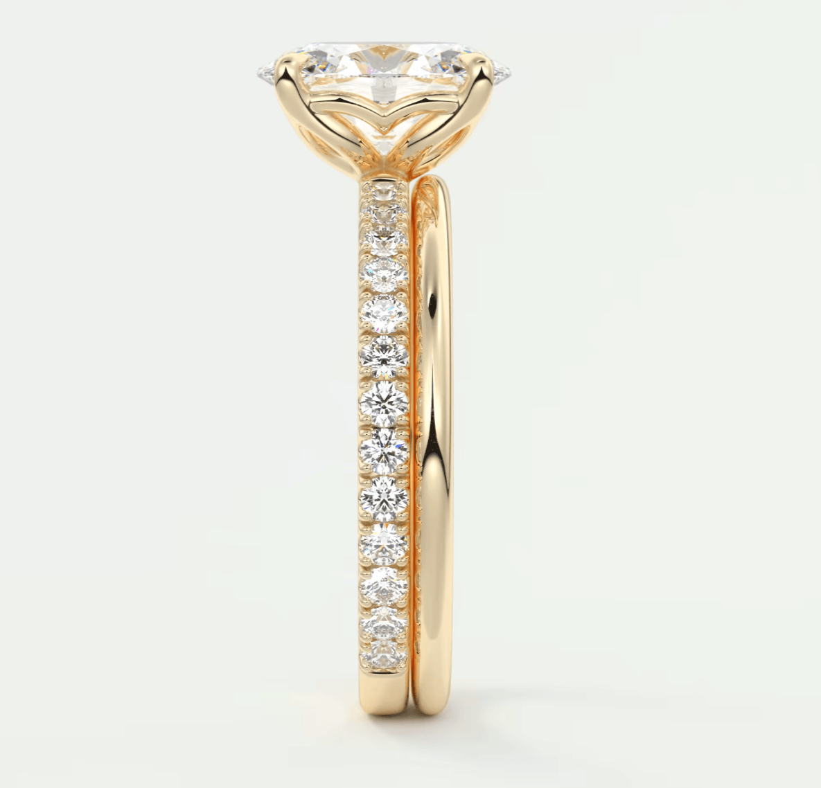 18-karat yellow gold engagement ring with a round diamond center and pavé-set diamonds on the band.