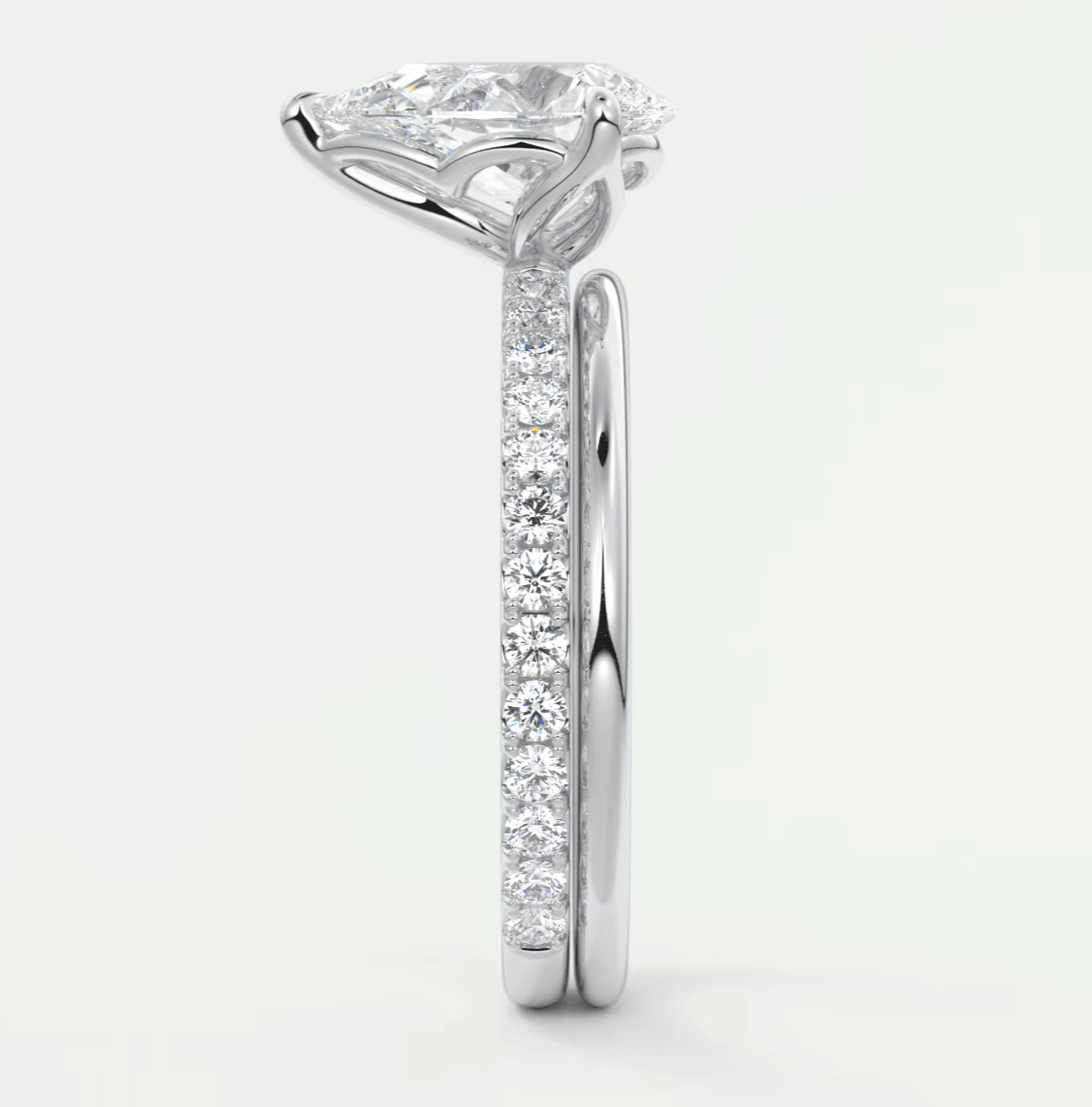 18-karat white gold engagement ring with a cushion-cut diamond center stone and pavé-set diamonds on the band.