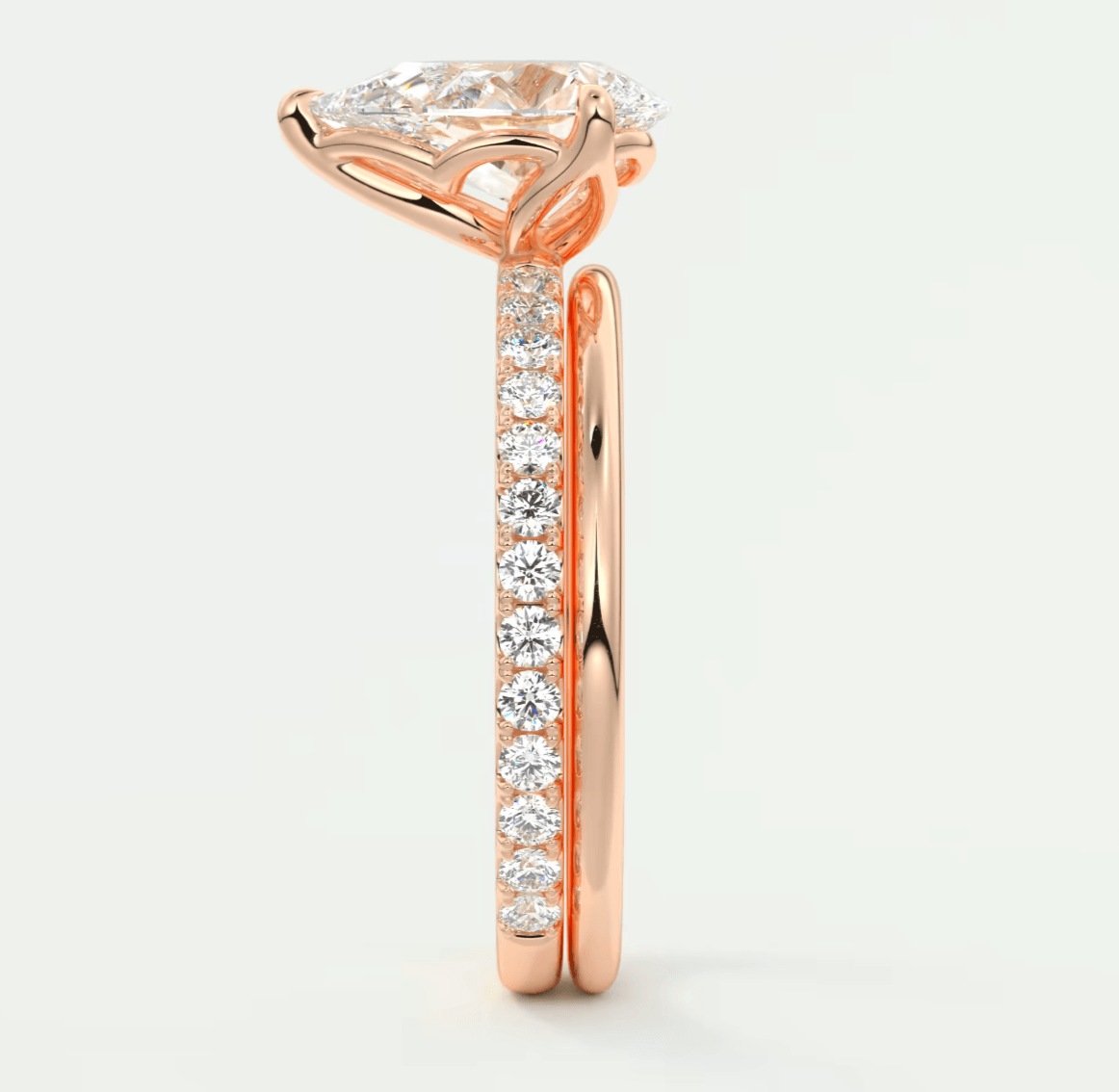 Rose gold diamond engagement ring with a princess cut center stone and pave set side stones.