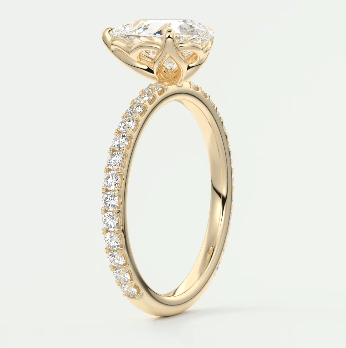 18-karat yellow gold engagement ring with a marquise-cut diamond and pavé-set diamonds on the band.