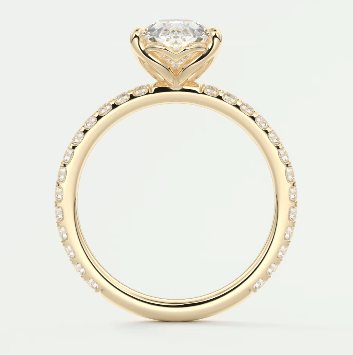 18-karat yellow gold engagement ring with a cushion-cut diamond and pavé diamonds on the band.
