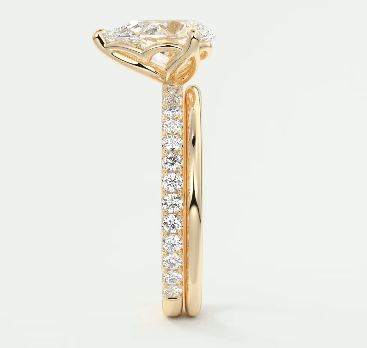 18-karat yellow gold engagement ring with a princess-cut diamond and pave-set diamonds on the band.