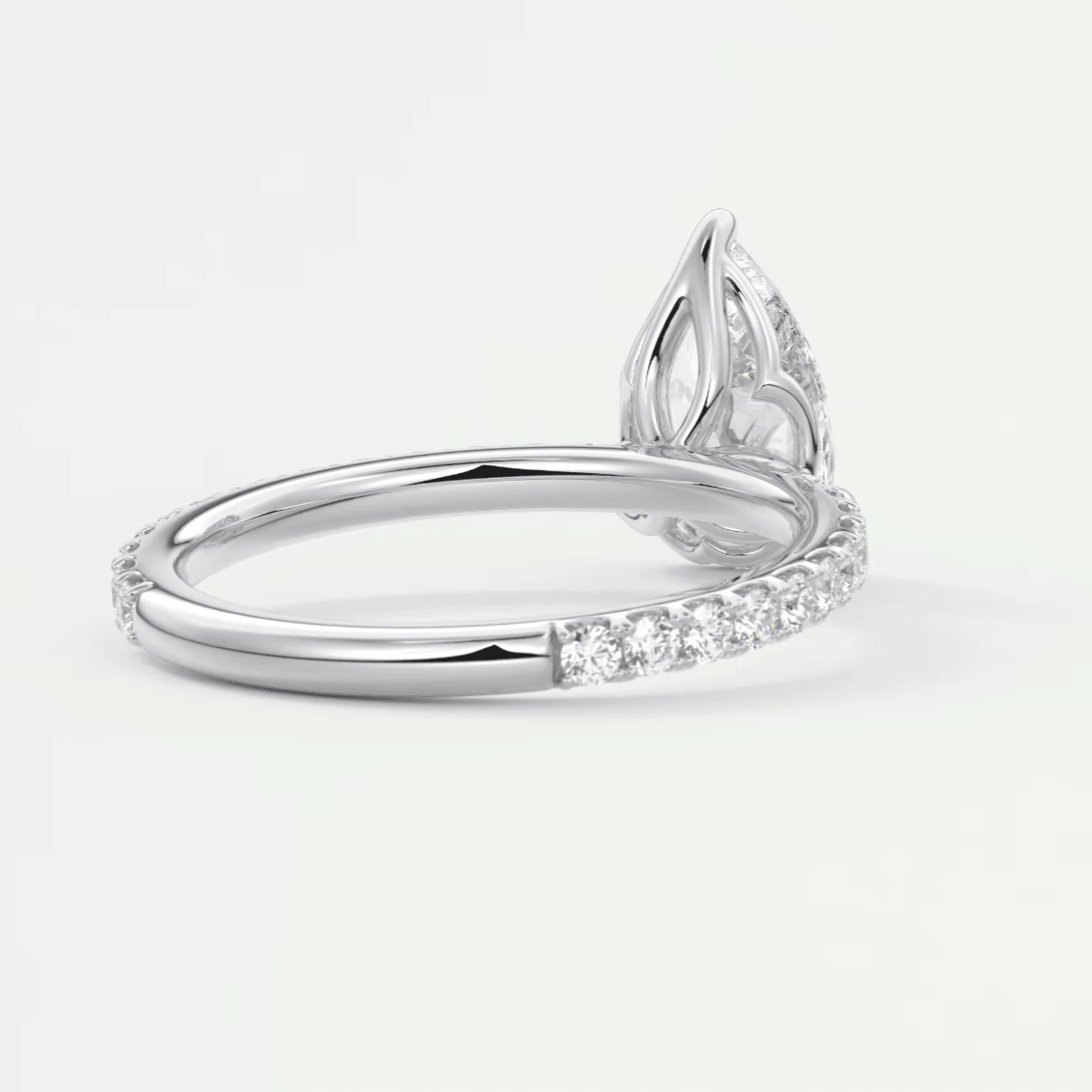 White diamond engagement ring with leaf design and pave setting.