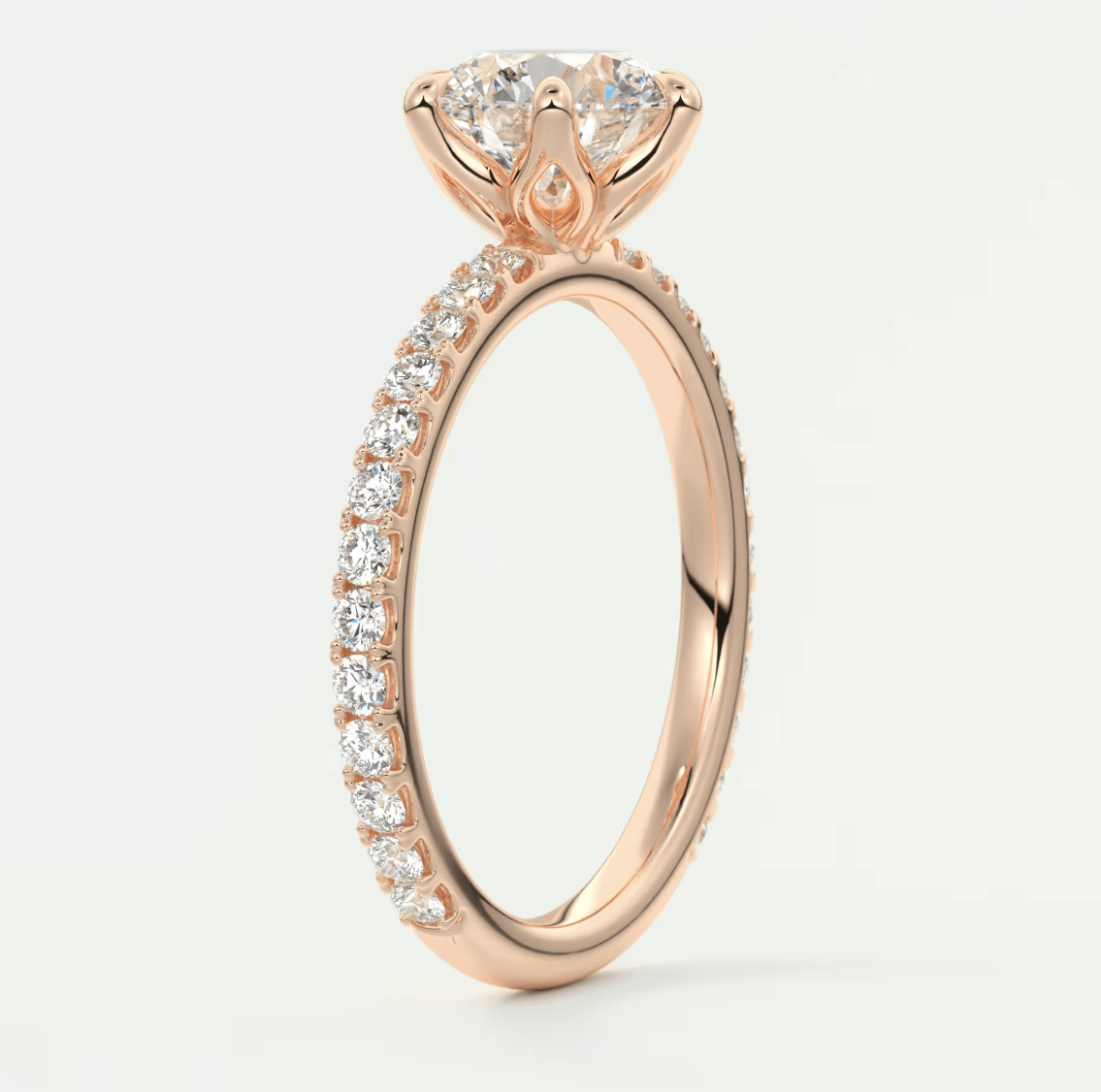 18-karat rose gold engagement ring with a princess-cut diamond and pavé side stones.