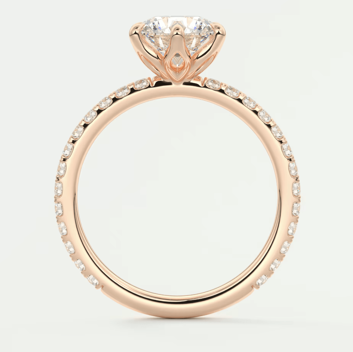 18k rose gold engagement ring with a heart-shaped diamond and pavé diamonds on the band.