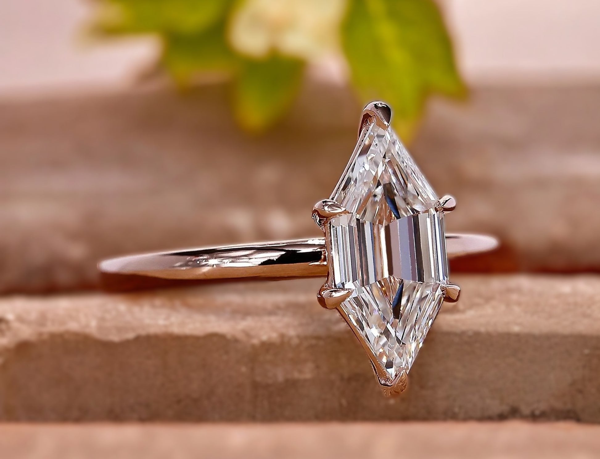 Diamond ring with a marquise-shaped gemstone on a textured surface