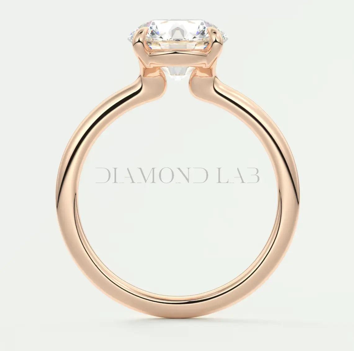 Rose gold diamond engagement ring with a square-cut gemstone and ’diamond lab’ engraving on the band.