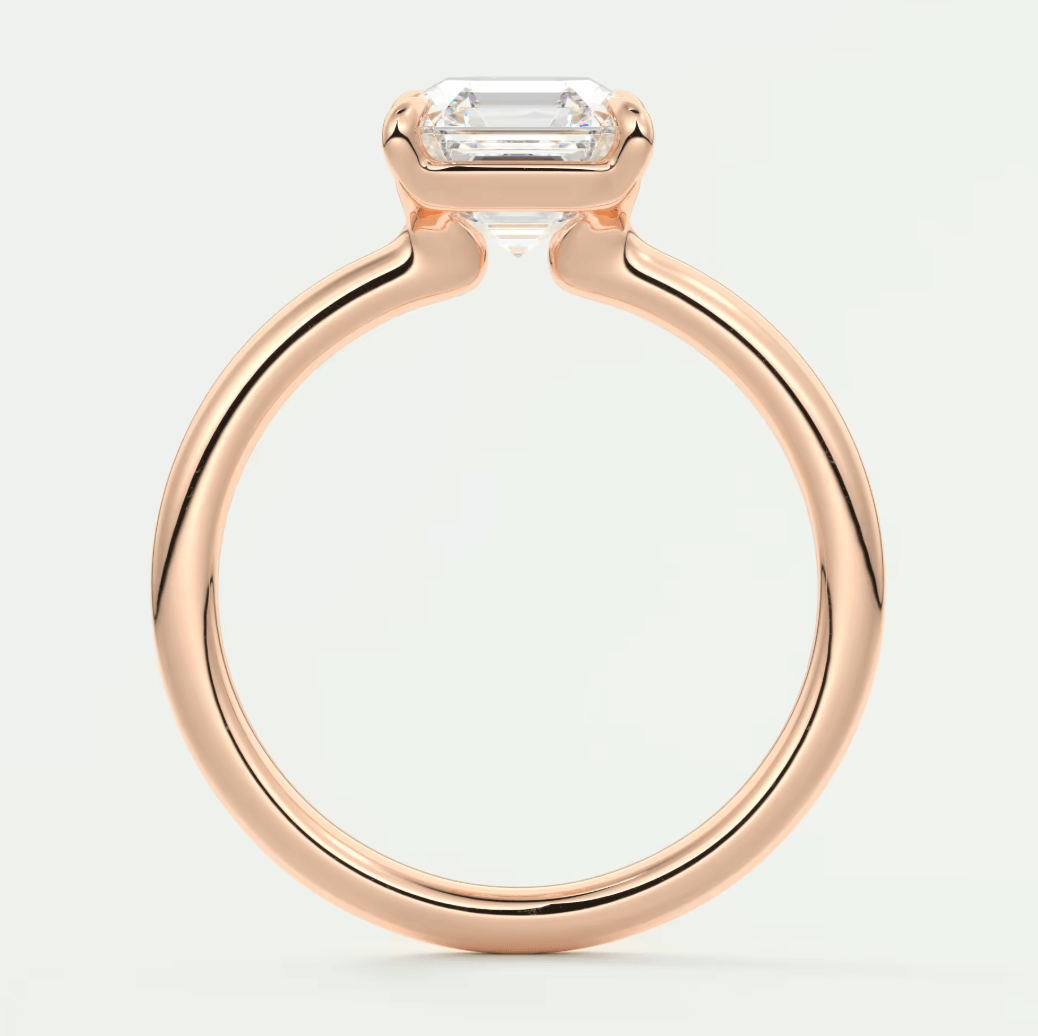 Rose gold emerald-cut diamond engagement ring with a sleek, modern design.