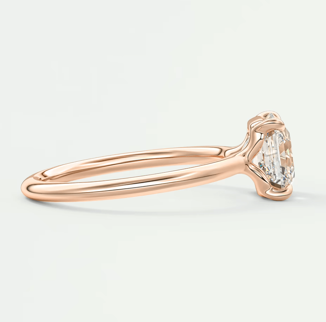 18-karat rose gold engagement ring with a round diamond.