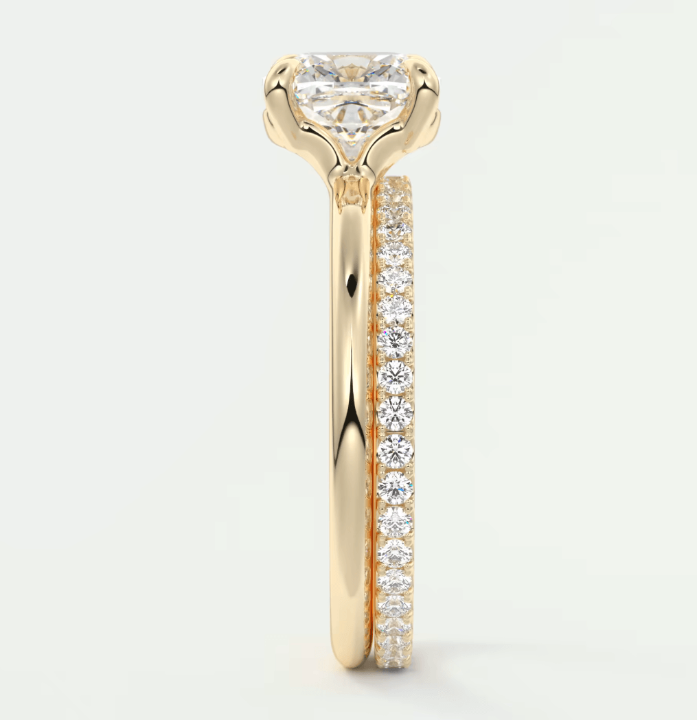 18k yellow gold engagement ring with a princess cut diamond and pave set side stones.