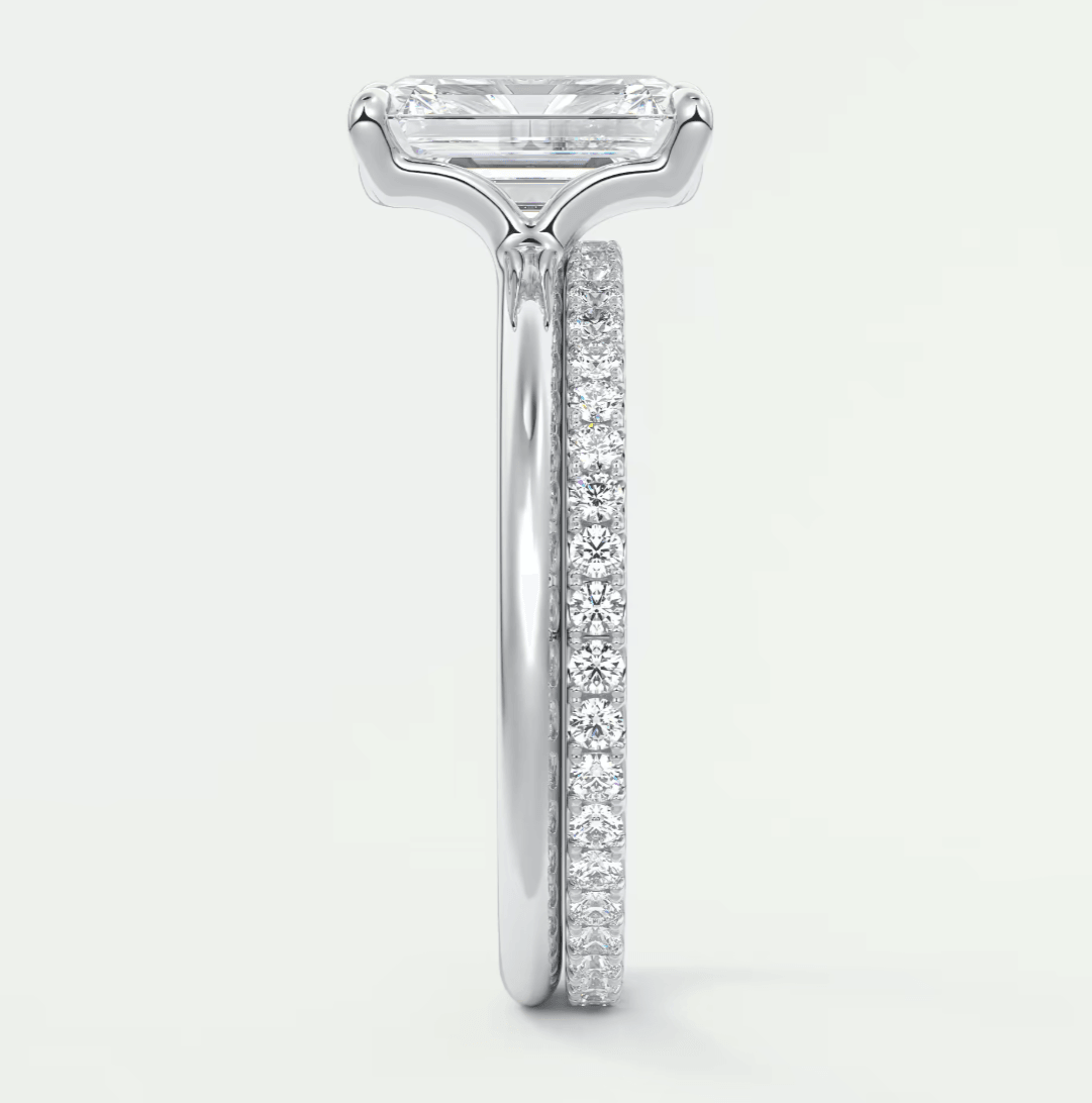 18k white gold diamond engagement ring with a baguette-cut center stone and pave set diamonds on the band.