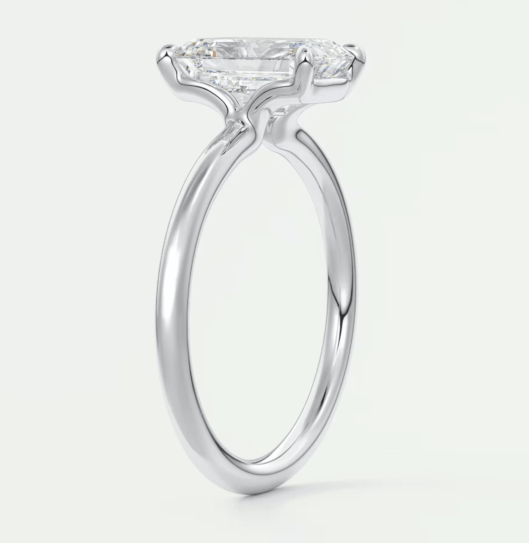 18-karat white gold engagement ring with a princess-cut diamond.