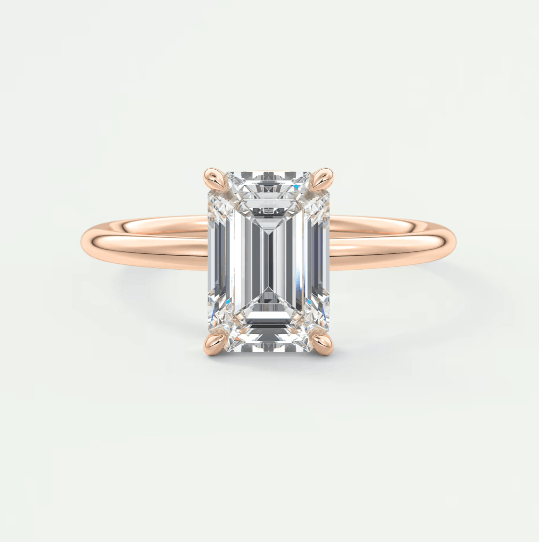 18k rose gold emerald cut diamond engagement ring with a solitaire design.
