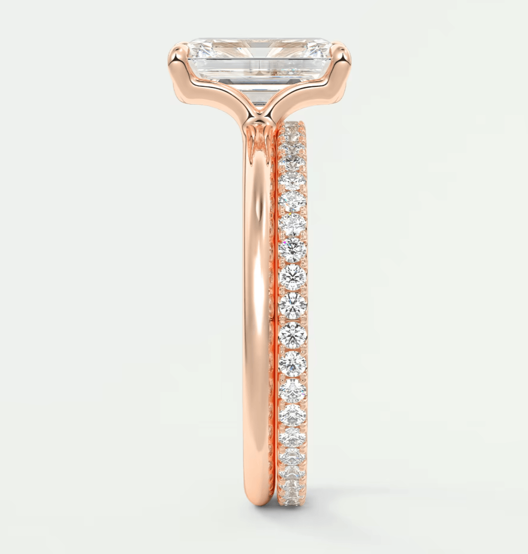 18-karat rose gold engagement ring with a rectangular diamond center and pavé diamonds on the band.