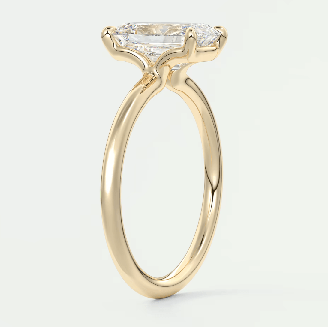 18-karat yellow gold engagement ring with a princess-cut diamond.