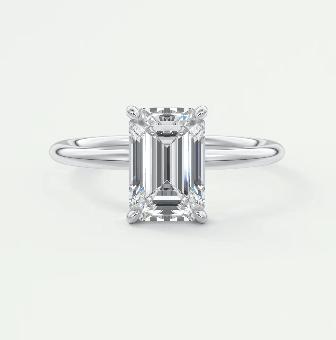 18k white gold emerald cut diamond engagement ring with a solitaire design.