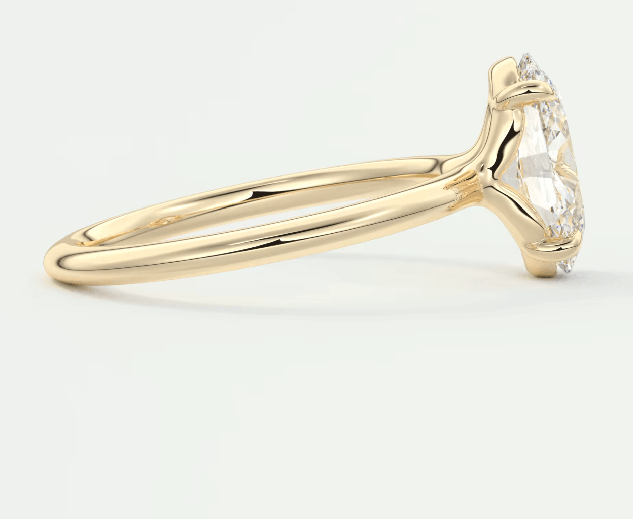 18k yellow gold engagement ring with a marquise-cut diamond.