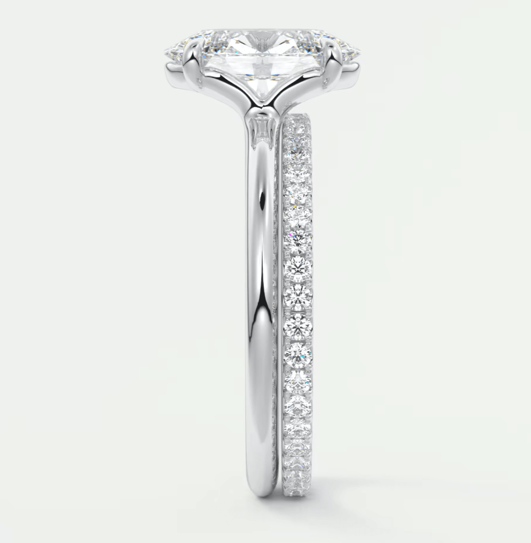 18k white gold engagement ring with a princess cut diamond and pave set side stones.