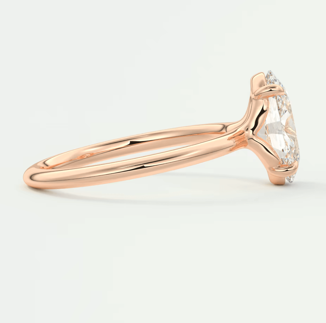 18-karat rose gold engagement ring with a marquise-cut diamond.