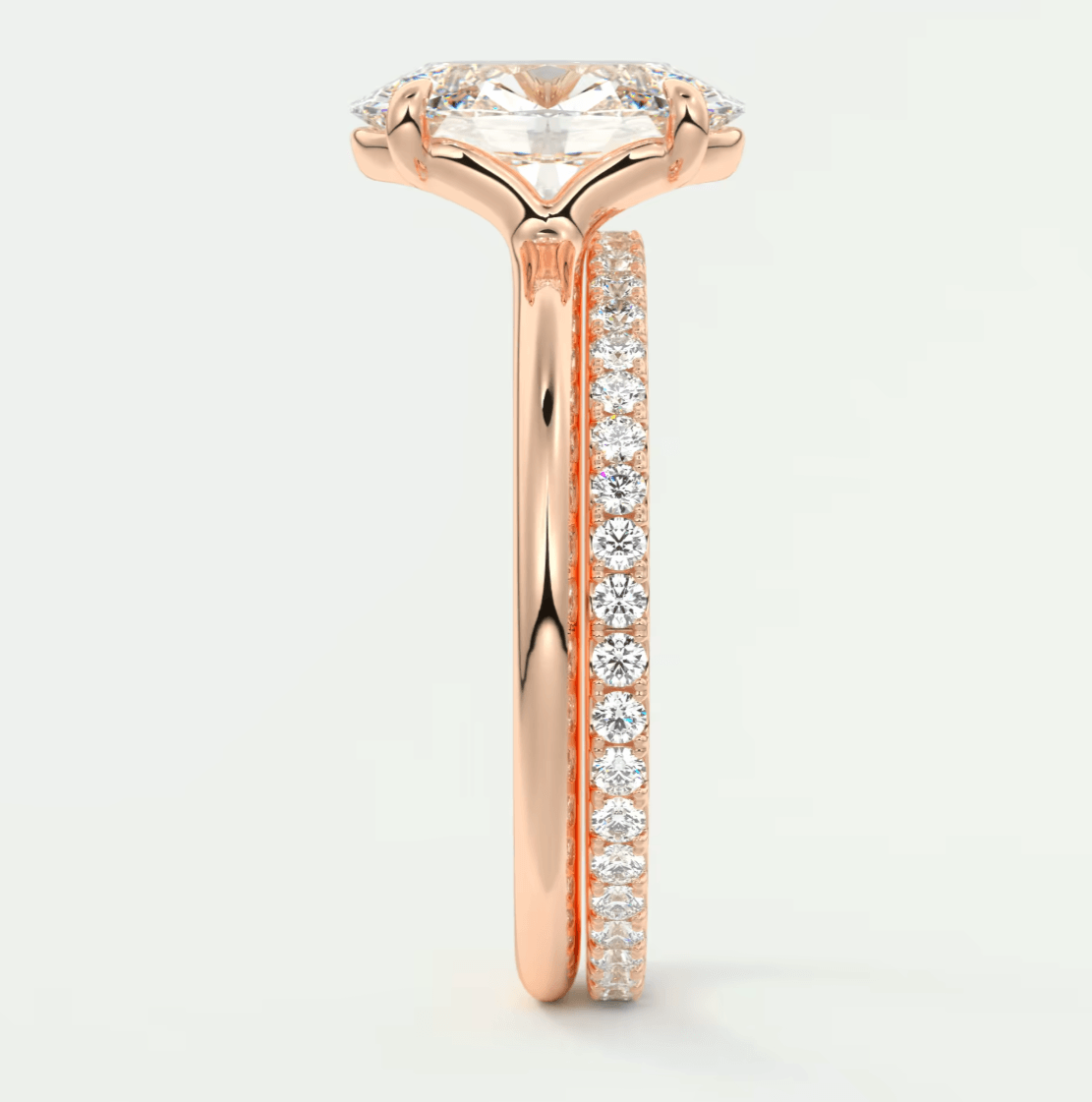 18-karat rose gold engagement ring with a princess-cut diamond and channel-set diamonds on the band.