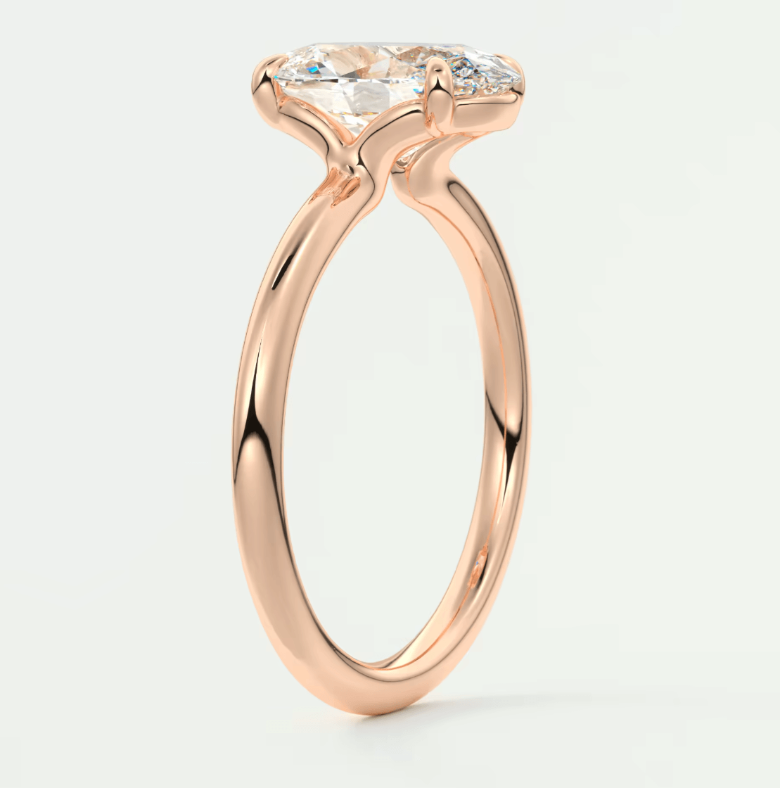 18-karat rose gold engagement ring with a marquise-cut diamond.