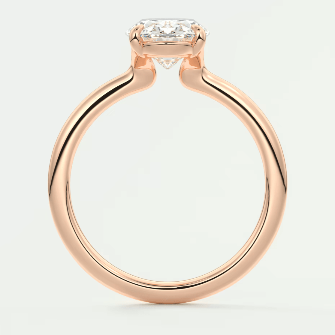 Rose gold engagement ring with emerald cut diamond, featuring a sleek and modern design.
