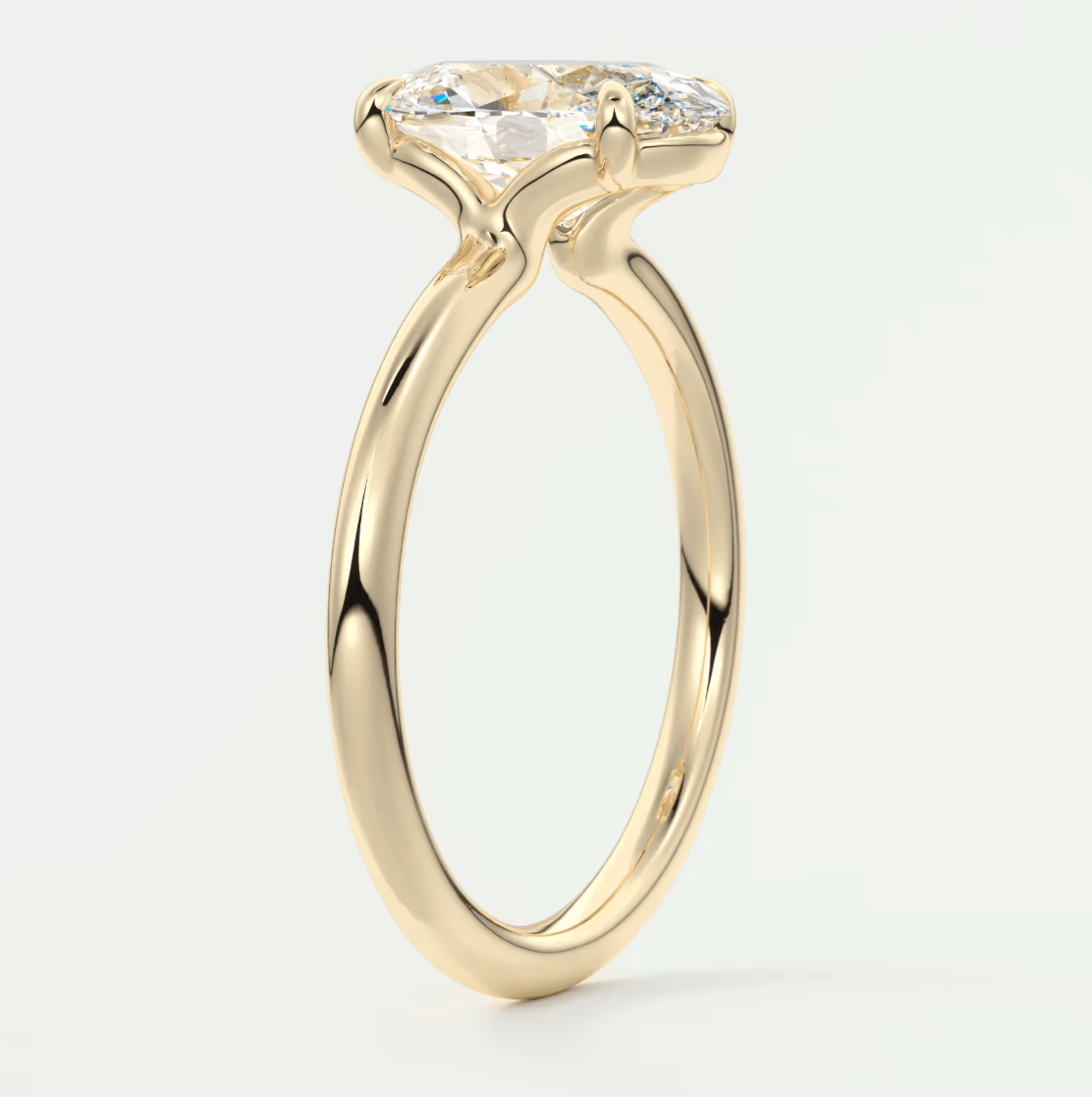 18k yellow gold engagement ring with a marquise-cut diamond.