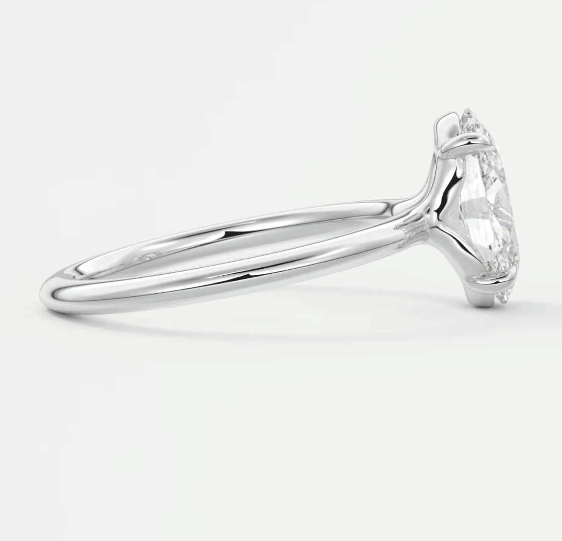 18k white gold engagement ring with a pear-shaped diamond.