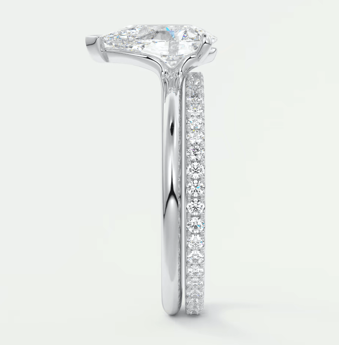 18-karat white gold engagement ring with a princess-cut diamond and pave-set diamonds on the band.