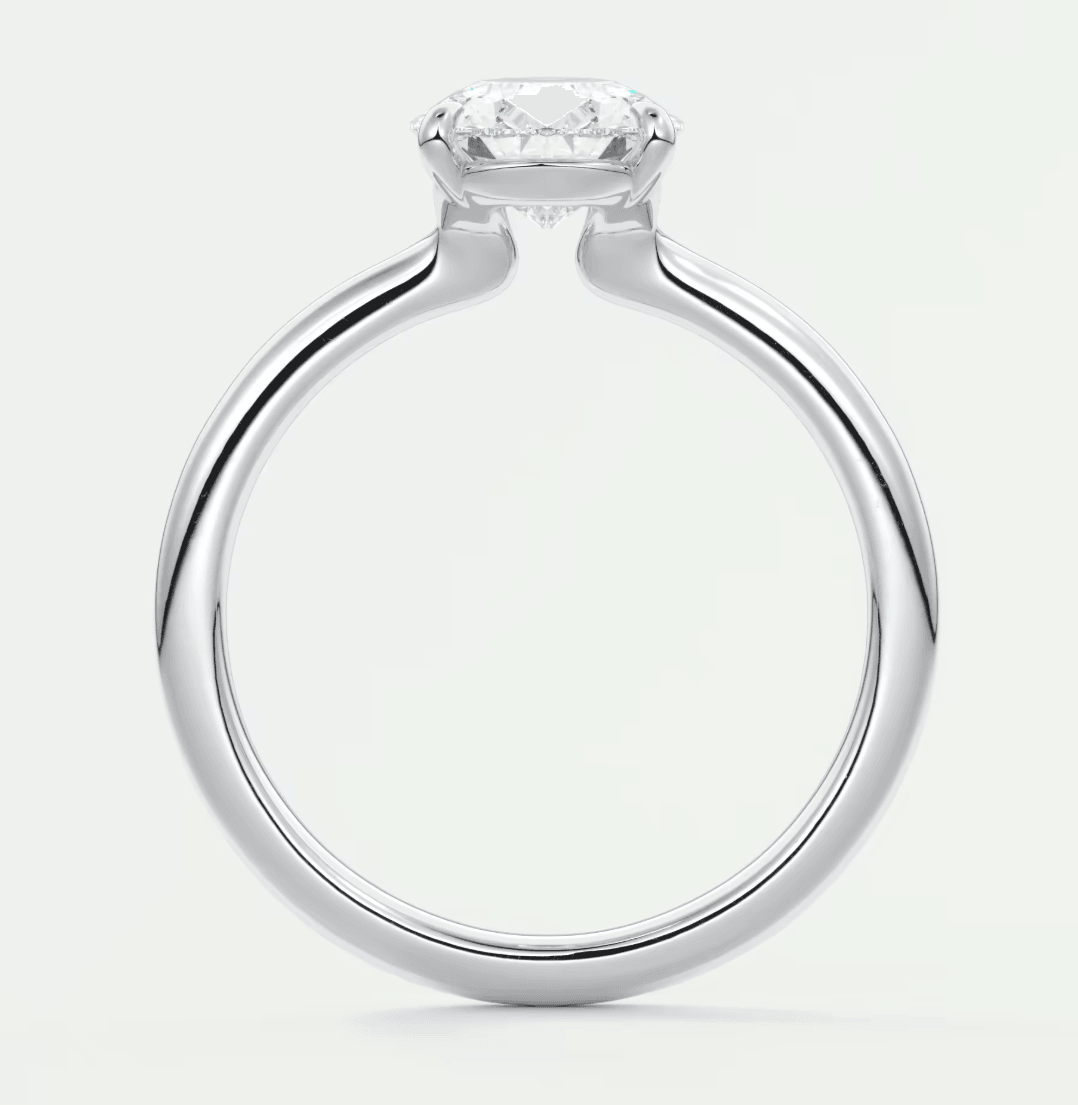Silver diamond engagement ring with a solitaire design and prong setting.