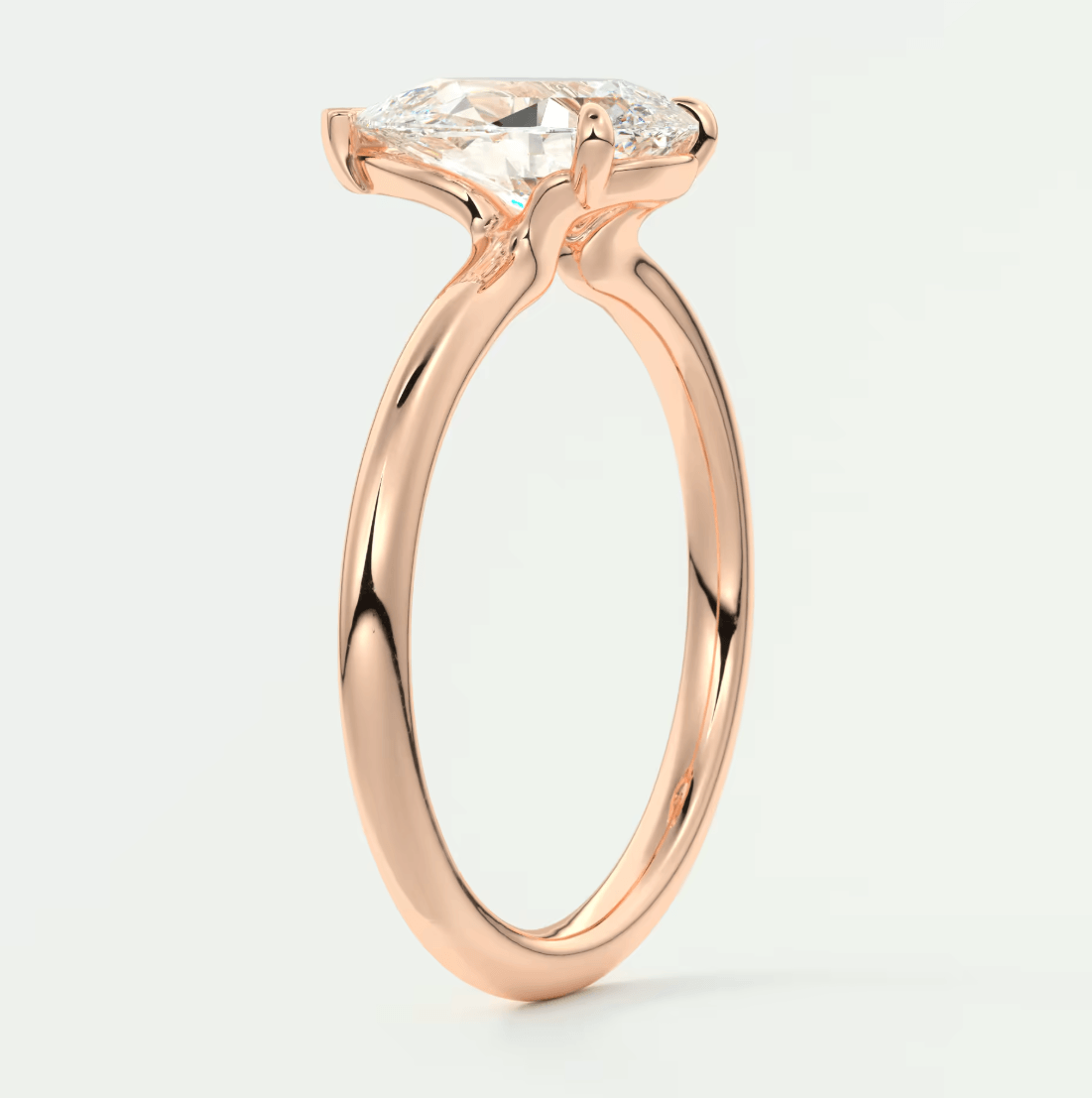 18-karat rose gold engagement ring with a marquise-cut diamond.
