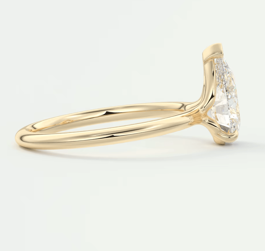 18k yellow gold engagement ring with marquise-cut diamond and small round diamonds on the band.