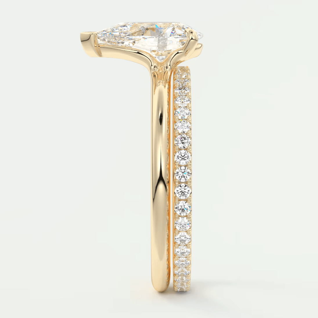 18k yellow gold engagement ring with a marquise-cut diamond center stone and pave-set diamonds on the band.