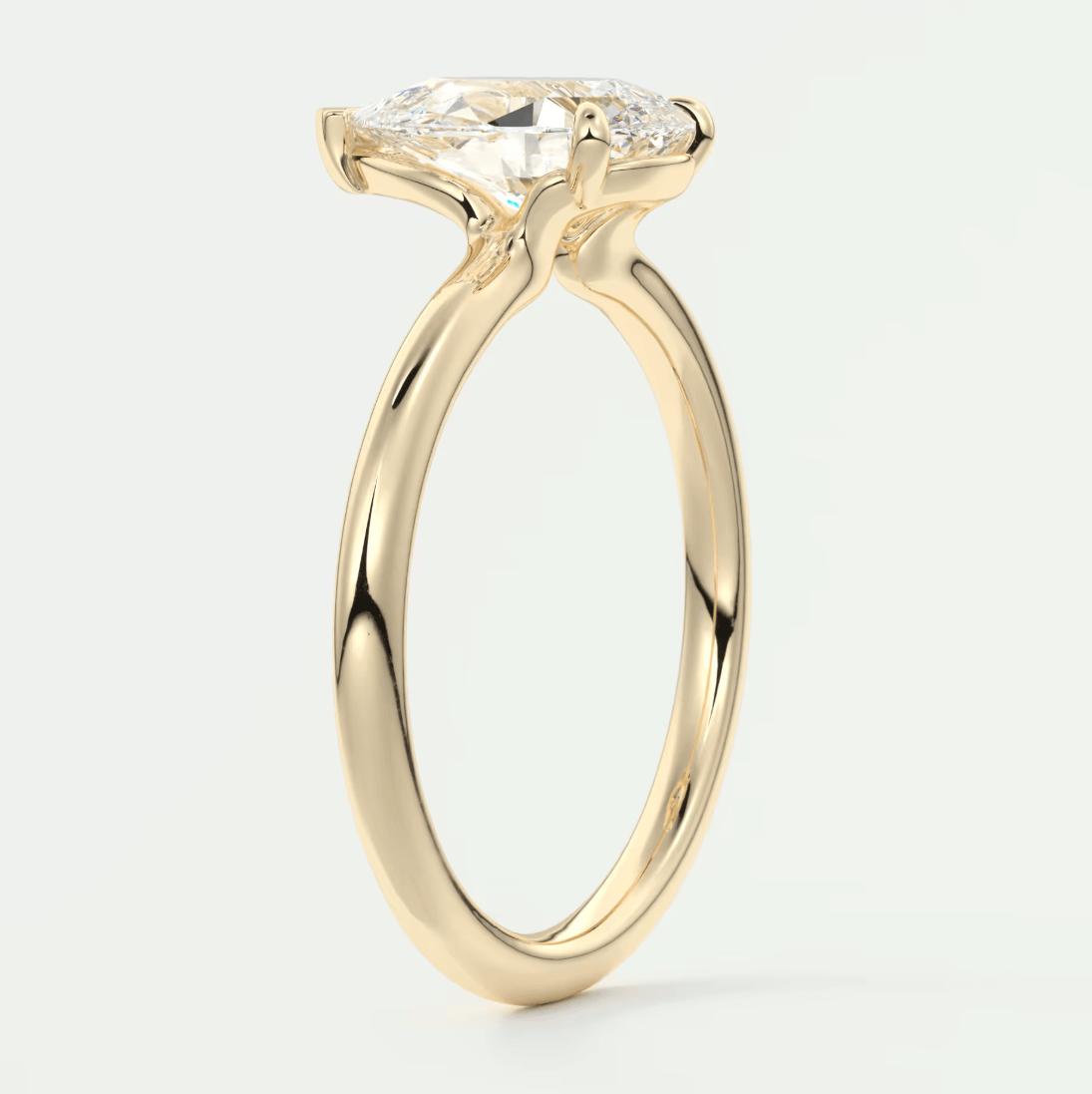 18k yellow gold engagement ring with a marquise-cut diamond.