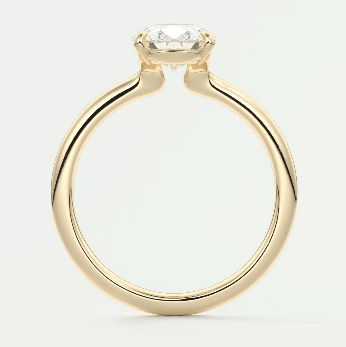 18-karat yellow gold engagement ring with a cushion-cut diamond.