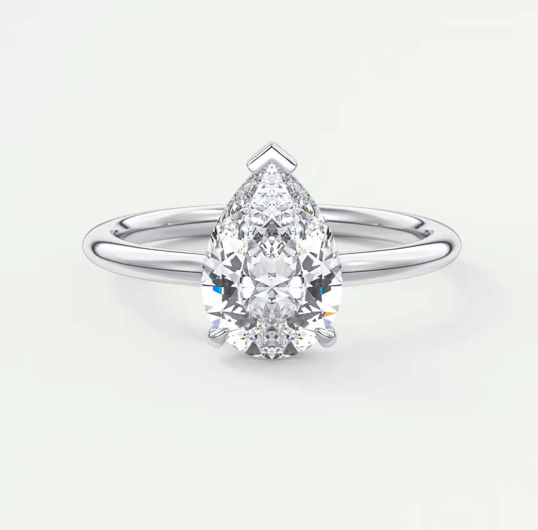 Pear-shaped diamond engagement ring with white gold band and prong setting.