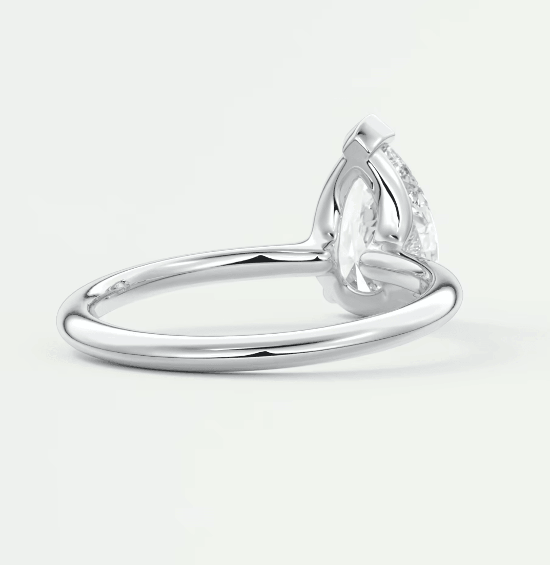 Pear-shaped diamond engagement ring with a white gold band.
