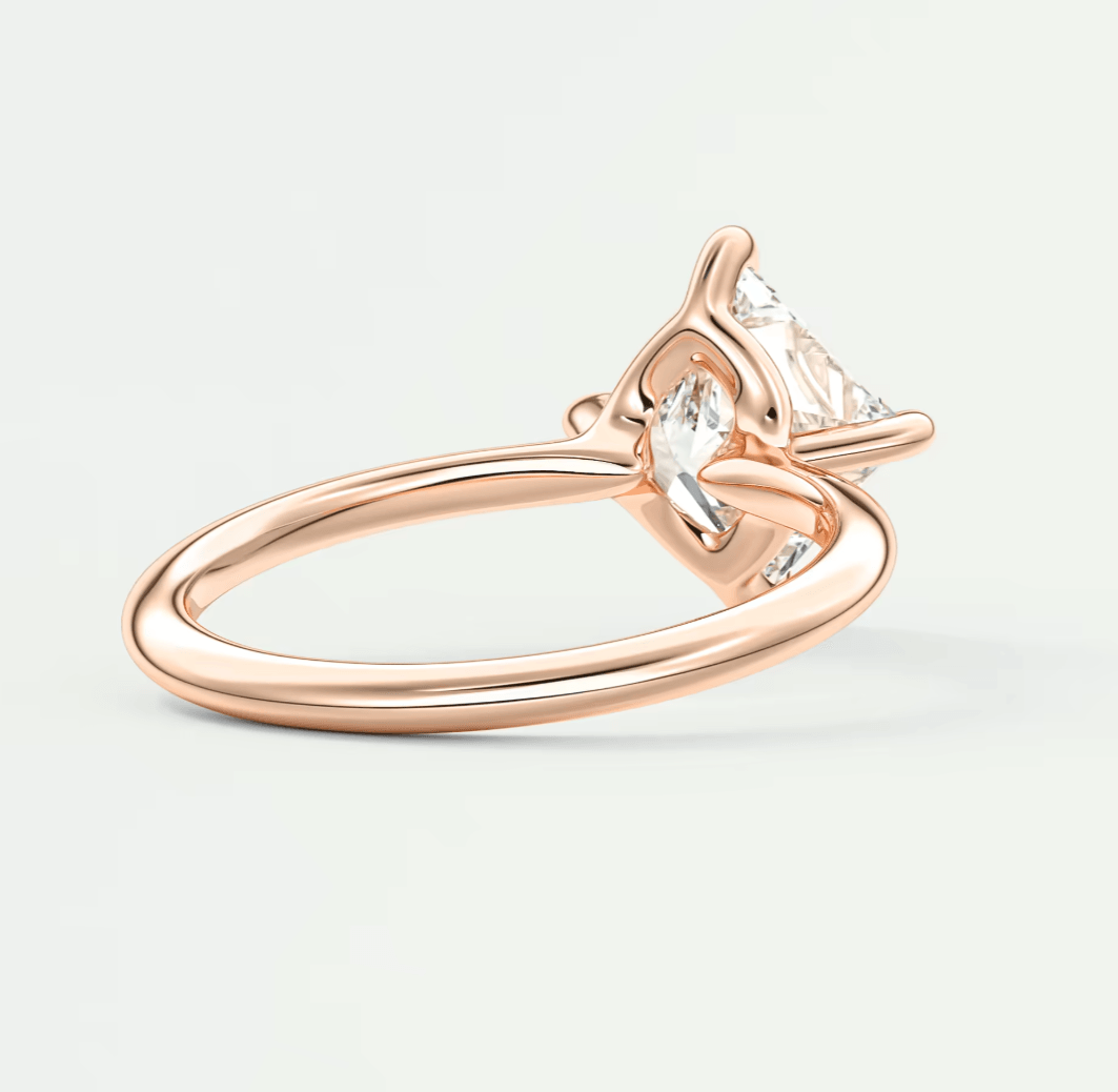18-karat rose gold engagement ring with a marquise-cut diamond.