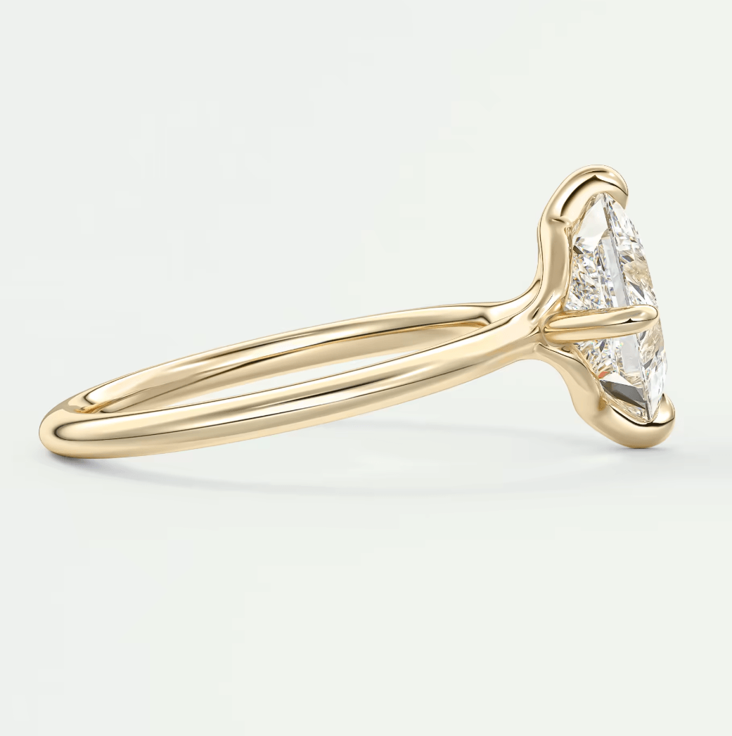 18k yellow gold engagement ring with a marquise-cut diamond.