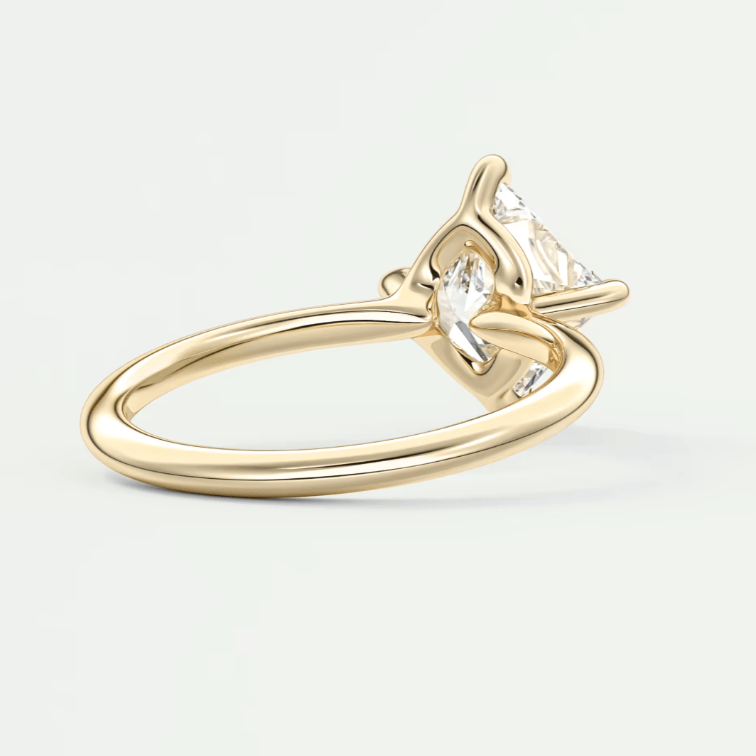 18k yellow gold engagement ring with a princess cut diamond.