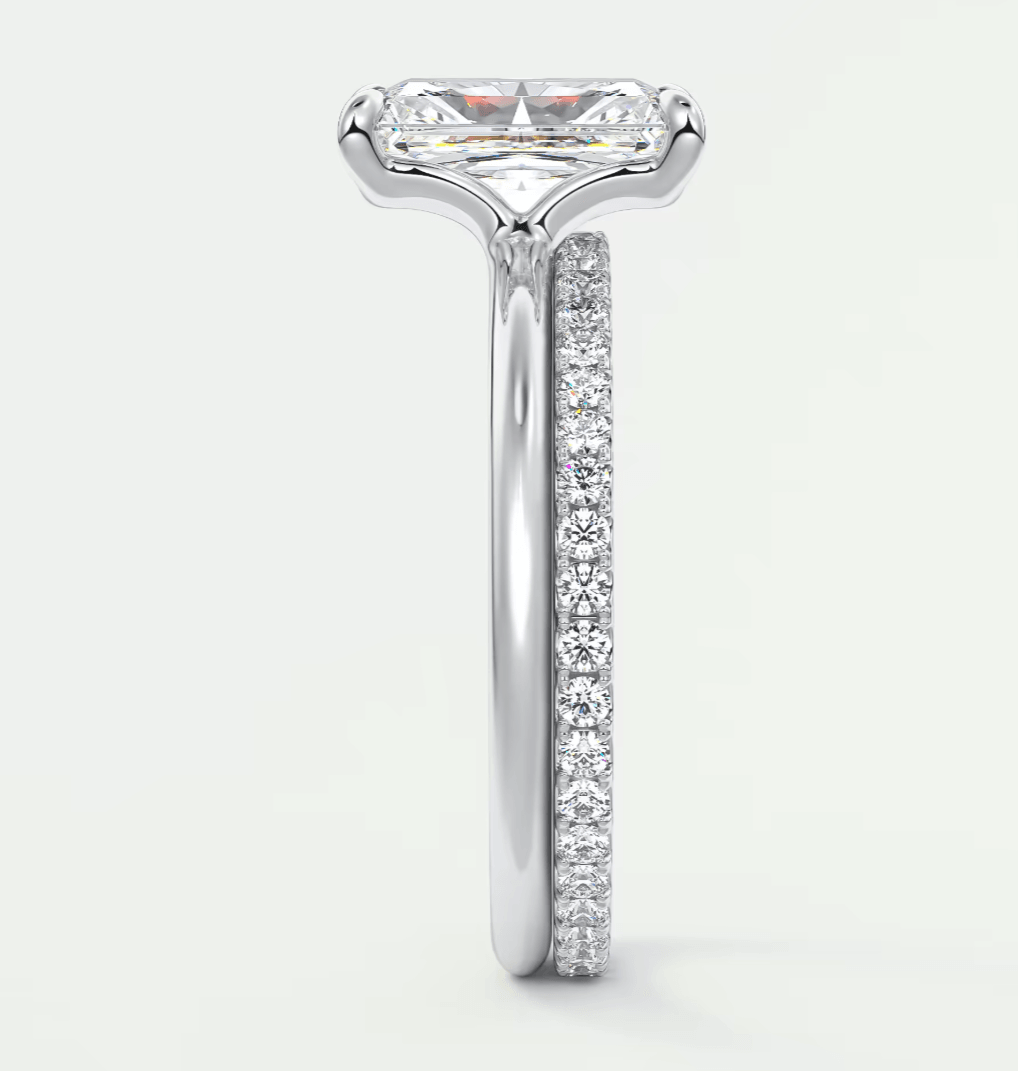 18k white gold engagement ring with a princess cut diamond and pave set diamonds on the band.