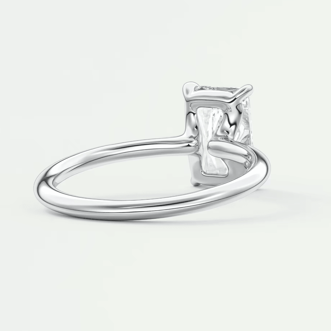 Silver diamond engagement ring with four-prong setting and simple band design.