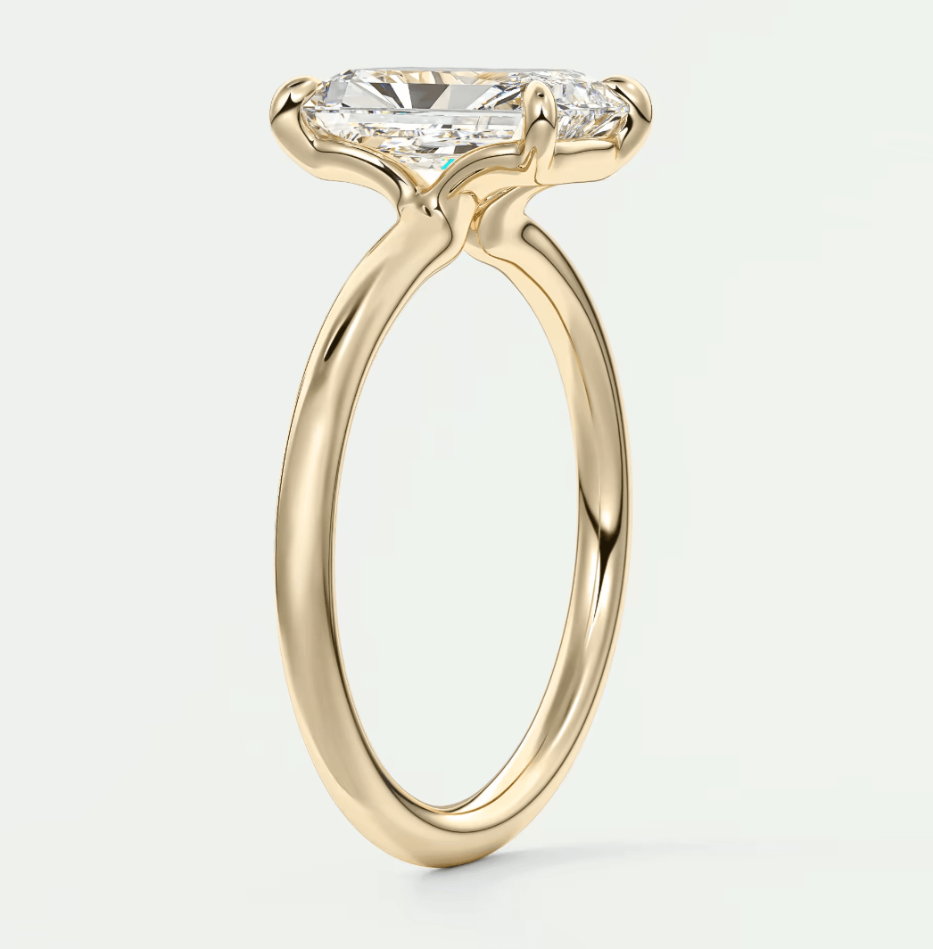 18-karat yellow gold engagement ring with a princess-cut diamond.