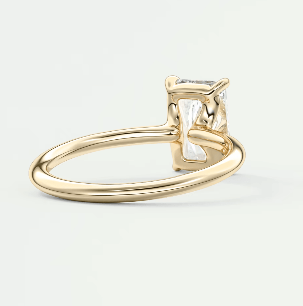 18k yellow gold emerald-cut diamond engagement ring.