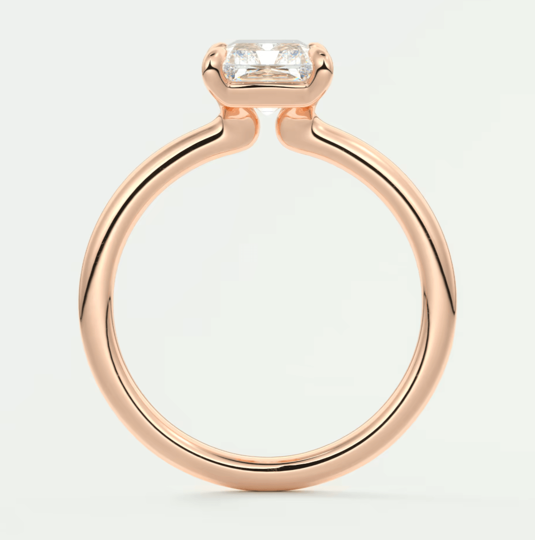 Rose gold diamond engagement ring with a square-cut gemstone.